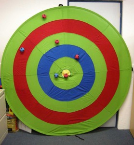 Multi-target: pop-up fabric target, standing against a wall, with velcro balls attached.